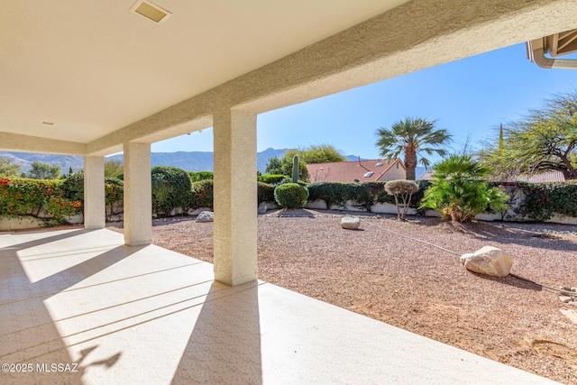 view of patio featuring visible vents, a fenced backyard, and a mountain view