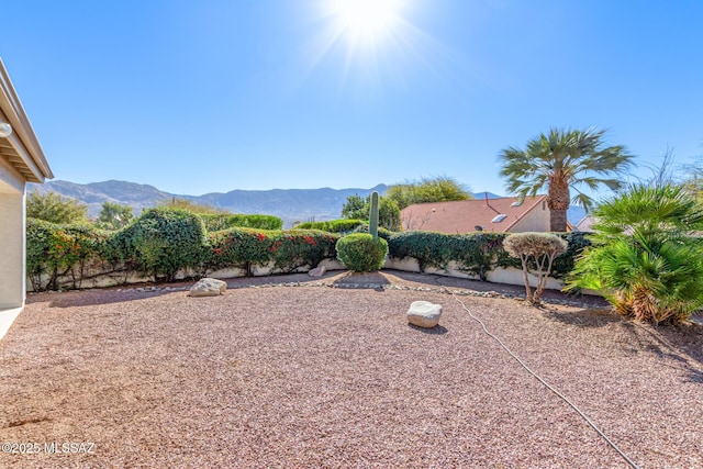 view of yard with a mountain view and fence