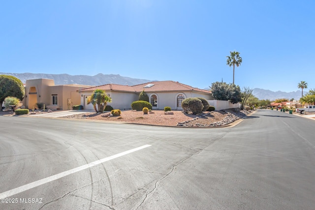 view of front of house with a mountain view and stucco siding