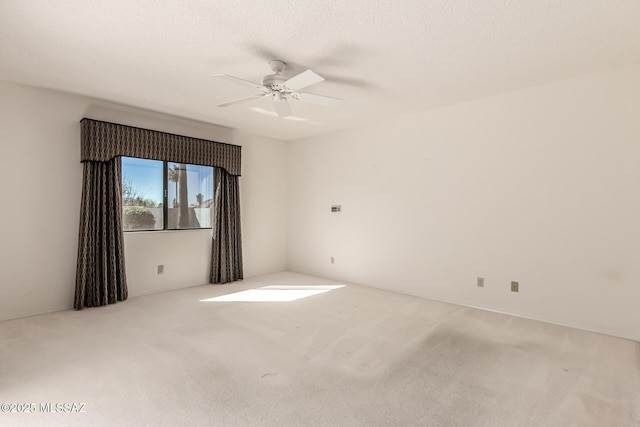 unfurnished room with carpet, a textured ceiling, and a ceiling fan