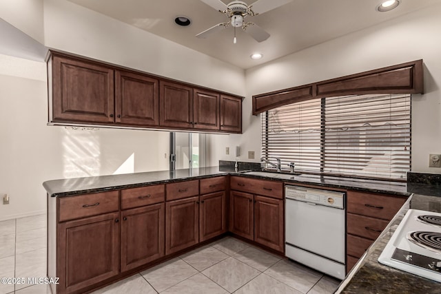 kitchen featuring light tile patterned flooring, a peninsula, white appliances, a sink, and a ceiling fan