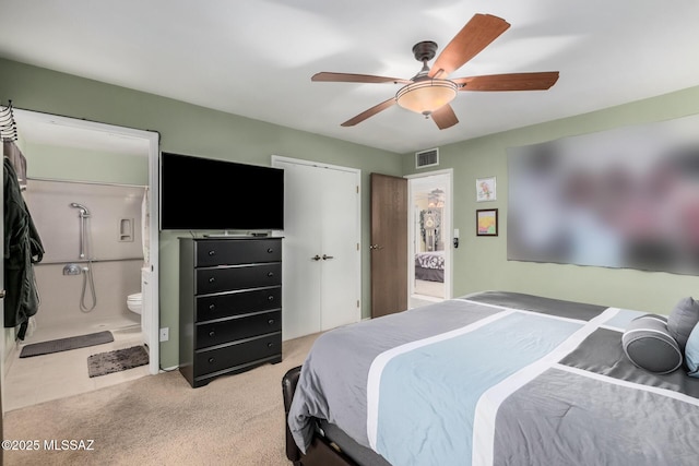 bedroom with visible vents, ceiling fan, light carpet, and ensuite bathroom