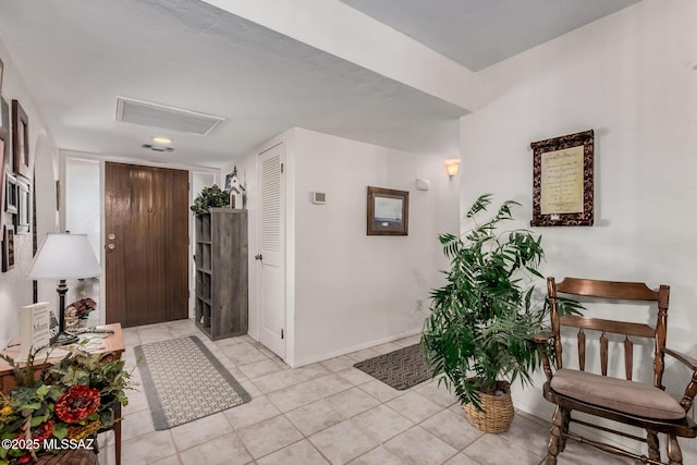 entrance foyer with light tile patterned flooring, visible vents, and baseboards