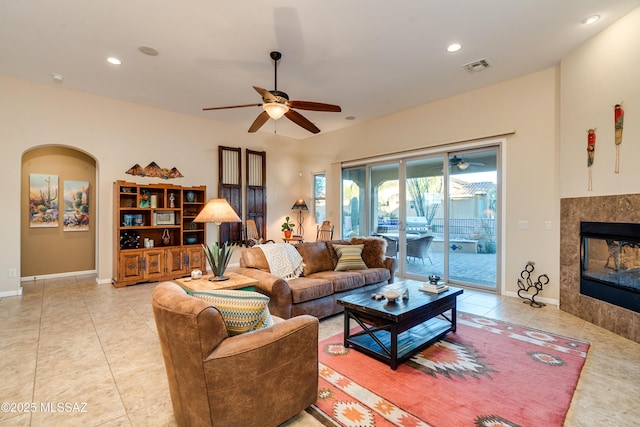 living area with recessed lighting, visible vents, a tiled fireplace, and light tile patterned flooring