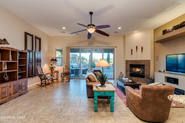 living area with ceiling fan, light tile patterned floors, a multi sided fireplace, and recessed lighting