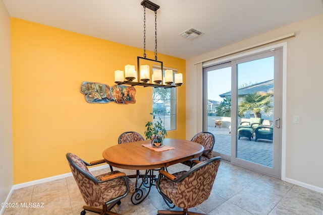 dining room with visible vents, a notable chandelier, baseboards, and light tile patterned flooring