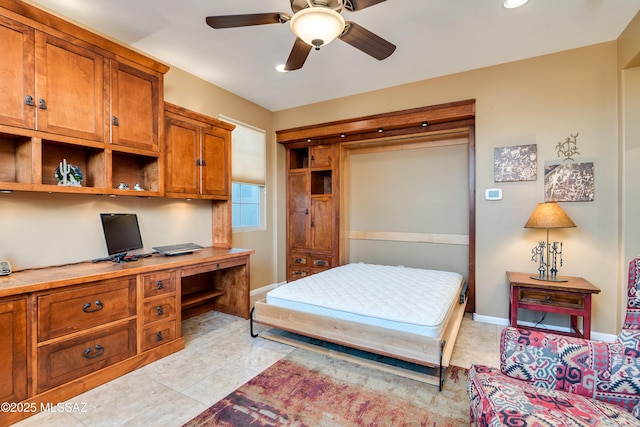 bedroom with light tile patterned floors, built in desk, and baseboards