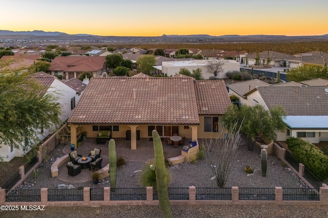 aerial view at dusk featuring a residential view and a mountain view