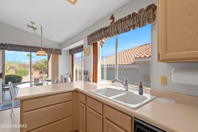 kitchen featuring light countertops, a sink, dishwasher, and light brown cabinetry