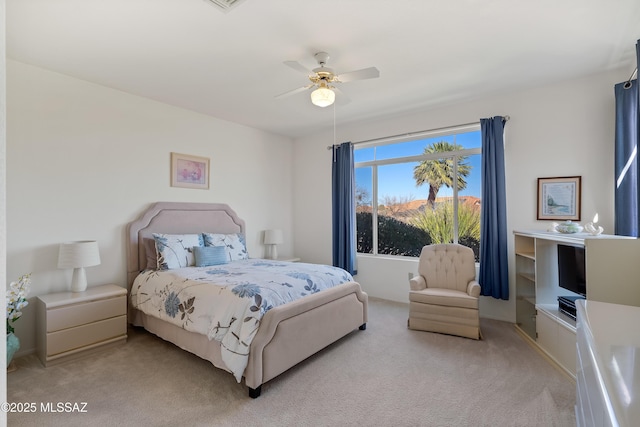 bedroom featuring light carpet and ceiling fan