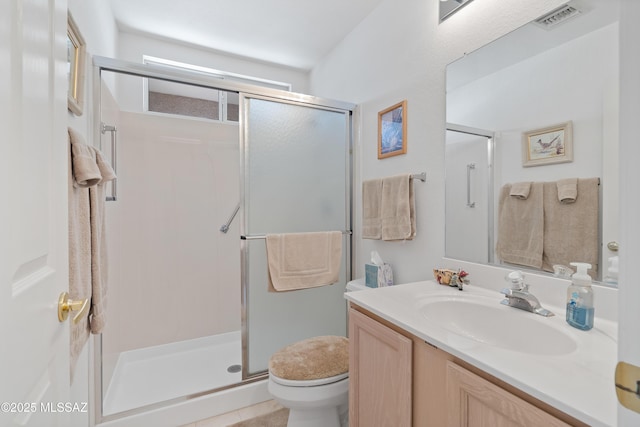 full bath featuring toilet, a stall shower, visible vents, and vanity