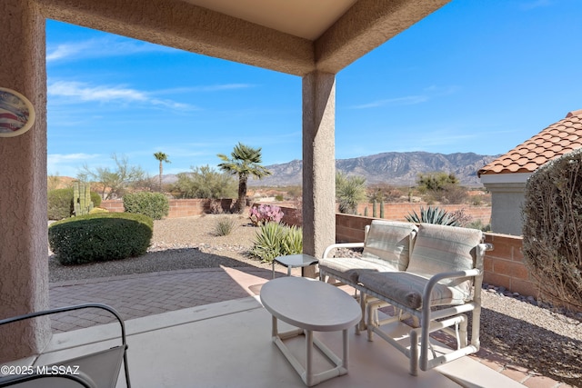 view of patio with a fenced backyard and a mountain view