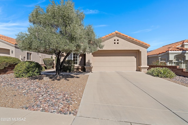 mediterranean / spanish house featuring a garage, driveway, a tile roof, and stucco siding