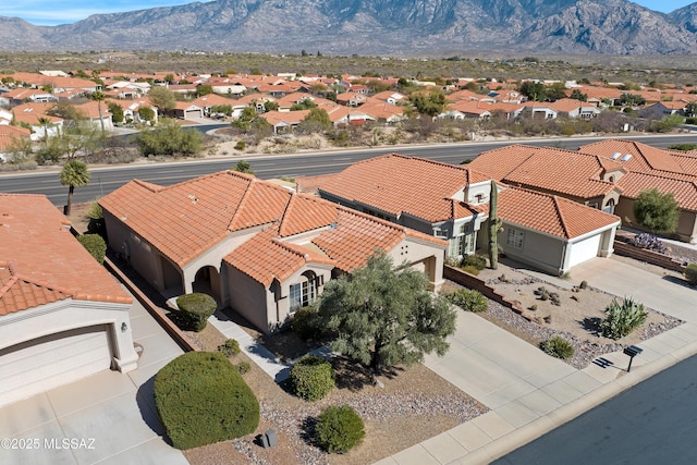 drone / aerial view featuring a residential view and a mountain view