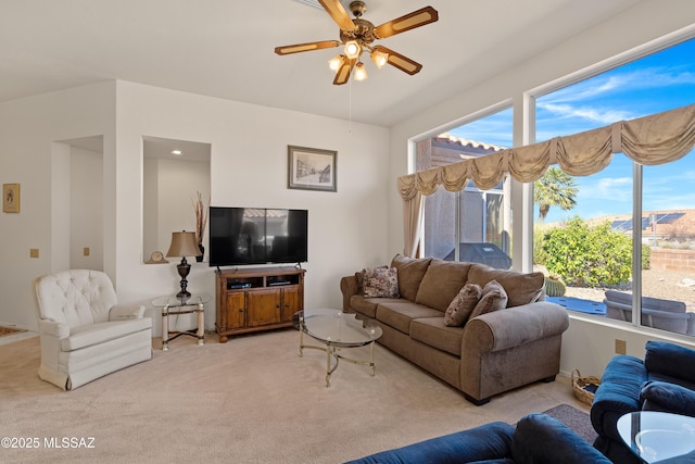 living area with light colored carpet and ceiling fan