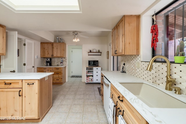 kitchen with light tile patterned floors, stainless steel microwave, a sink, ceiling fan, and dishwasher