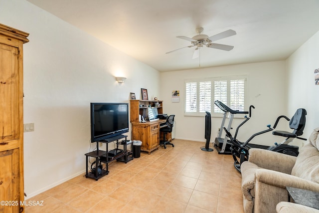 exercise room featuring light tile patterned floors, ceiling fan, and baseboards