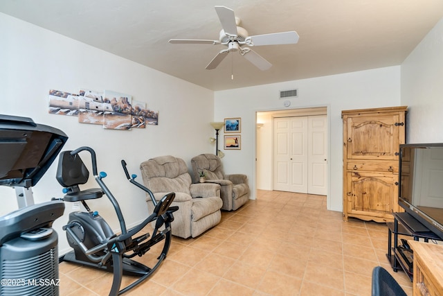 workout room with a ceiling fan, visible vents, and light tile patterned flooring