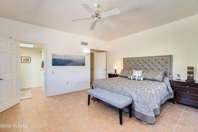 bedroom with ceiling fan, light tile patterned flooring, visible vents, and baseboards