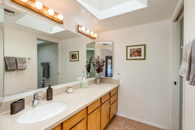 bathroom featuring tile patterned floors, visible vents, baseboards, and vanity