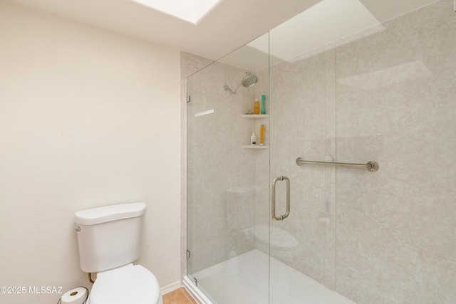 bathroom featuring toilet and a shower stall