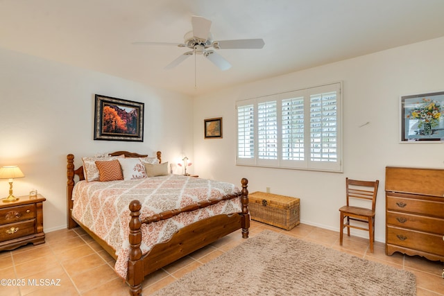 tiled bedroom featuring ceiling fan and baseboards