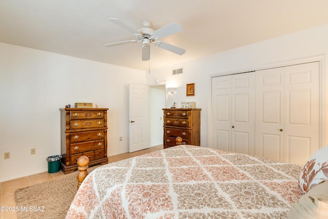 tiled bedroom featuring a closet, visible vents, and ceiling fan