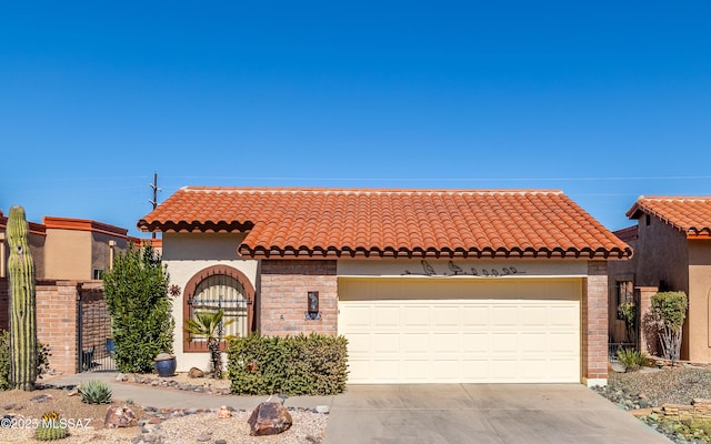 mediterranean / spanish-style home with a tiled roof, driveway, and stucco siding