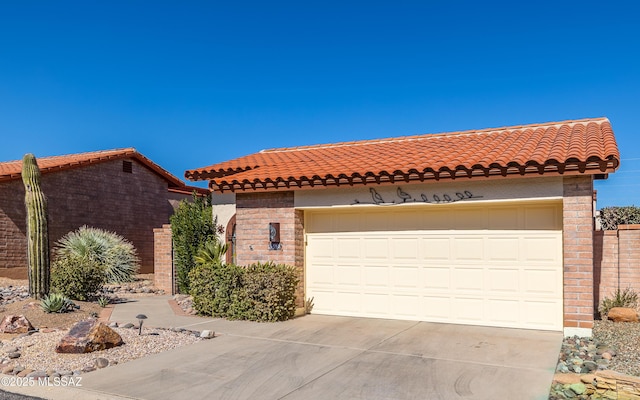 mediterranean / spanish-style home with a garage, driveway, and a tiled roof