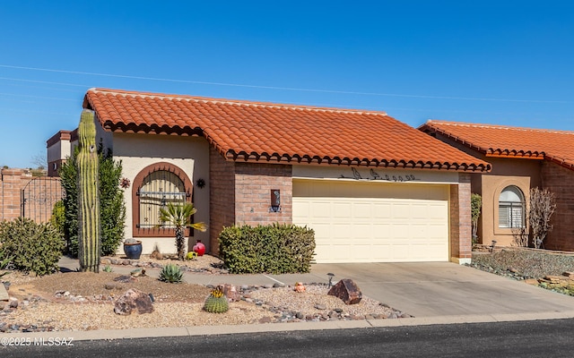 mediterranean / spanish-style home with a tiled roof, concrete driveway, an attached garage, and stucco siding