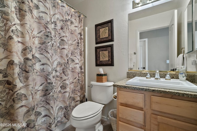 full bathroom with toilet, vanity, and a shower with curtain