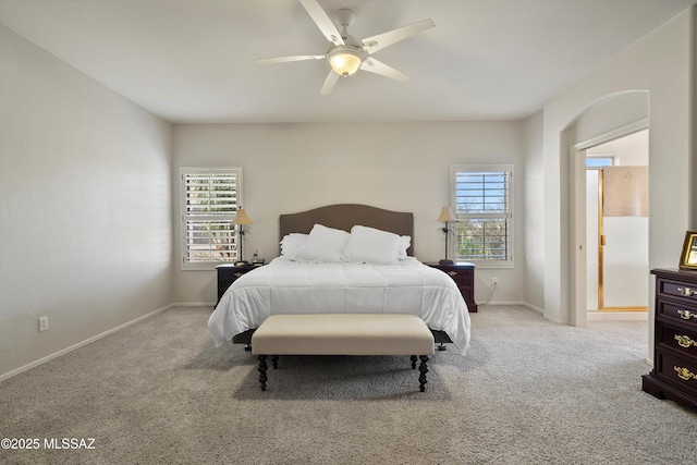 bedroom featuring light carpet, ceiling fan, and baseboards