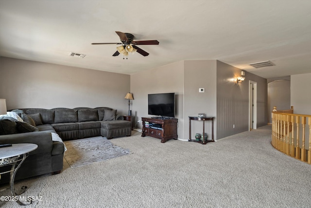 living area with light carpet, visible vents, and a ceiling fan