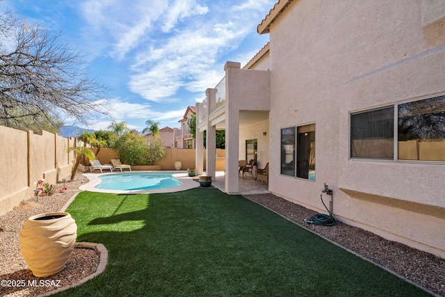 view of yard featuring a fenced backyard, a fenced in pool, and a patio