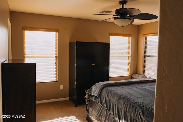 bedroom featuring a ceiling fan, carpet, visible vents, and baseboards