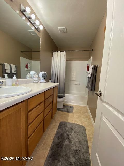 bathroom with toilet, tile patterned flooring, vanity, and visible vents