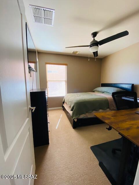 bedroom with ceiling fan, visible vents, and light colored carpet