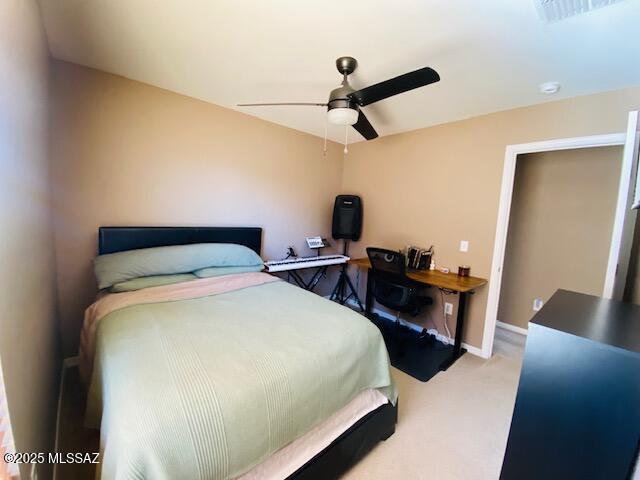 carpeted bedroom featuring visible vents, ceiling fan, and baseboards