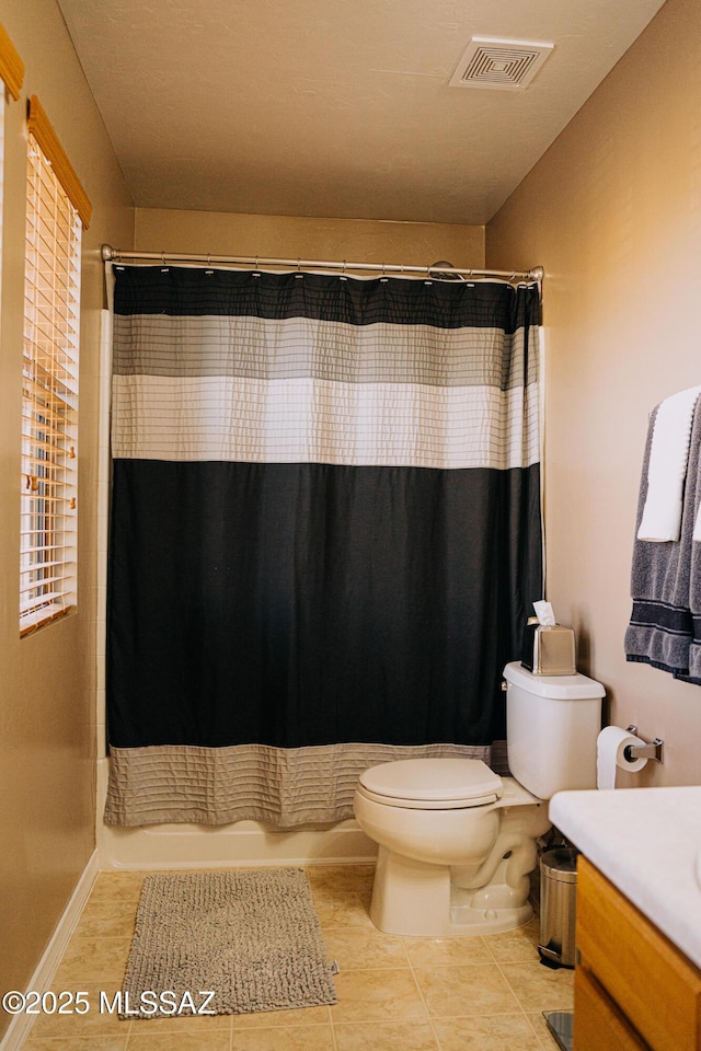 full bath with toilet, vanity, visible vents, tile patterned floors, and shower / bathtub combination with curtain