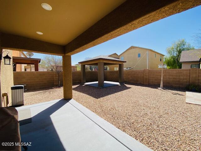 view of patio featuring a fenced backyard and a gazebo