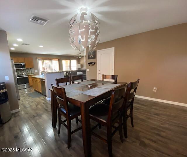 dining area featuring dark wood-style flooring, recessed lighting, visible vents, and baseboards