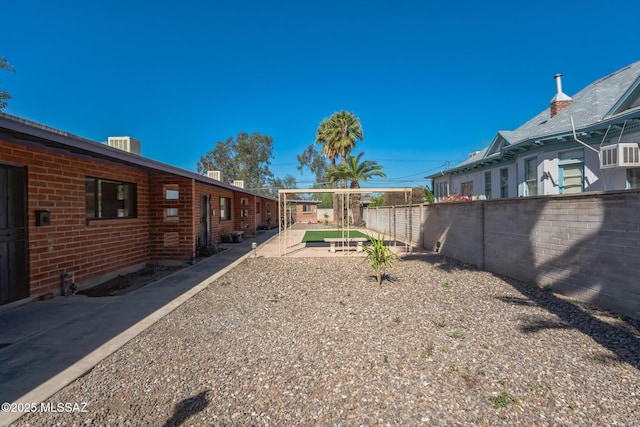 view of yard with a patio area, a fenced backyard, and central air condition unit