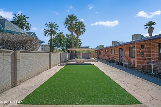 view of yard featuring a patio area and a fenced backyard