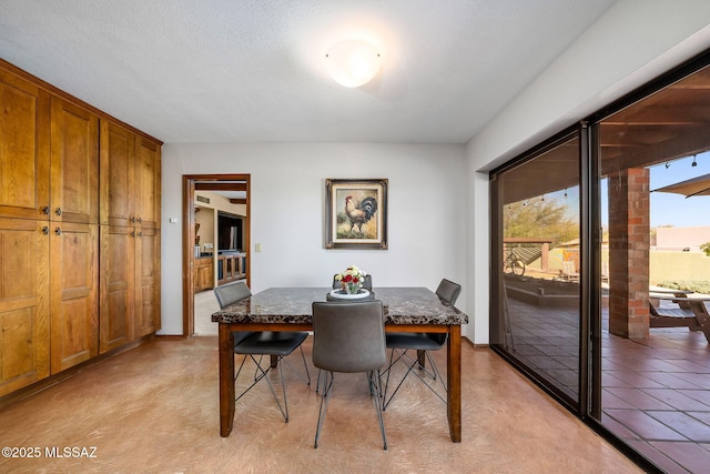 dining space with a textured ceiling