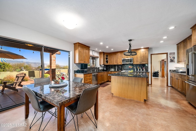 kitchen with recessed lighting, tasteful backsplash, stainless steel appliances, and a center island