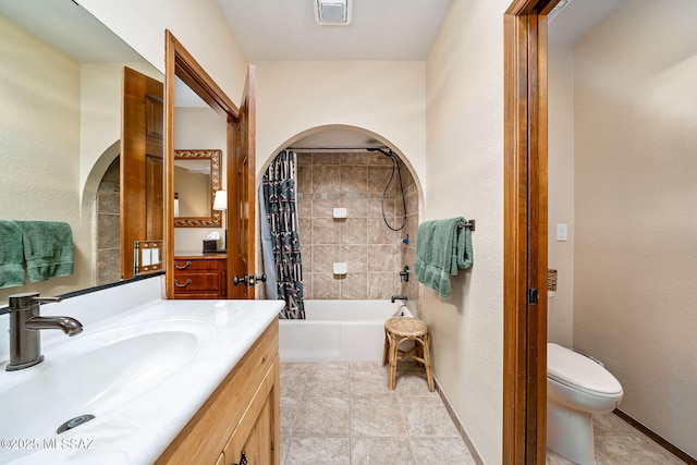 bathroom featuring toilet, visible vents, vanity, tile patterned floors, and shower / bathtub combination with curtain