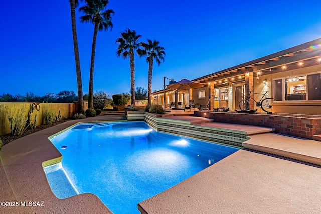 view of pool featuring fence, a fenced in pool, and a patio