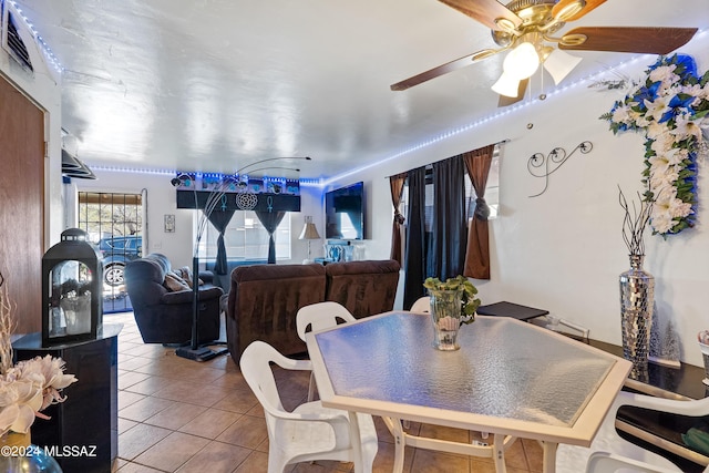 dining room featuring ceiling fan, visible vents, and tile patterned floors