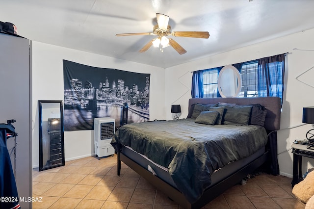 tiled bedroom featuring heating unit and ceiling fan