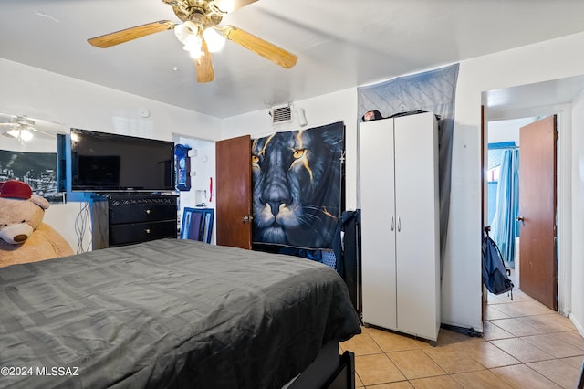 bedroom with a ceiling fan, visible vents, and light tile patterned floors